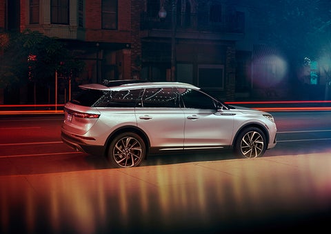 A 2023 Lincoln Corsair® SUV is shown parked in the city at night. | Lincoln Cosmos Demo in Derwood MD